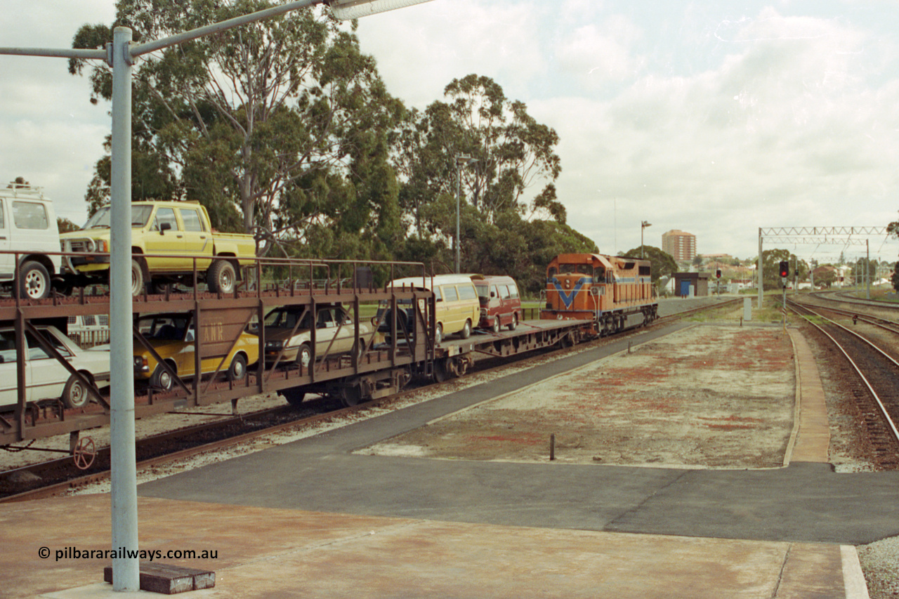 209-04
East Perth Passenger Terminal, Westrail L class L 272 Clyde Engineering EMD model GT26C serial 69-621 shunts the car carrying waggons into the unloading dock off the Indian Pacific.

