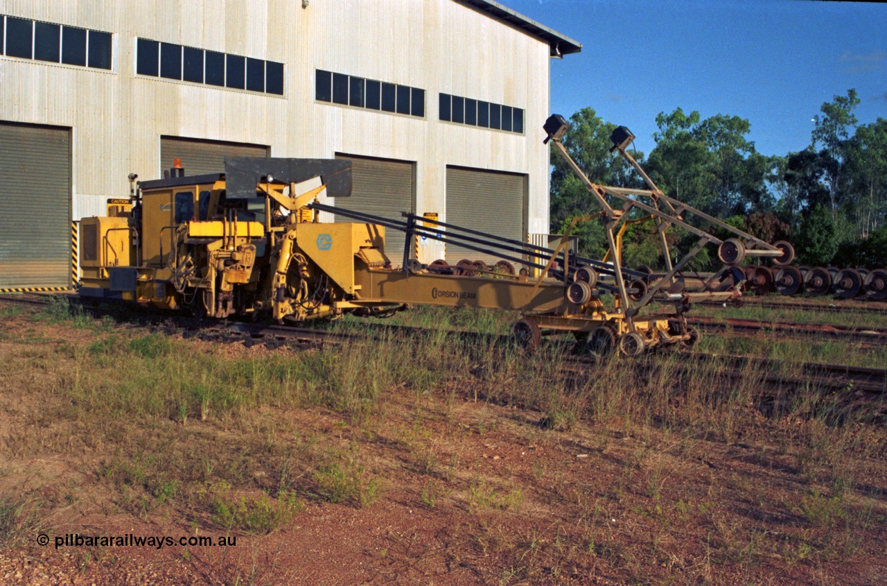 213-15
Weipa, Lorim Point workshops building, looking south east at the rear of the building. Canron Rail Group Mk I switch tamper. Canron was taken over by Harsco in 1990-91.
Keywords: Canron;track-machine;Comalco;