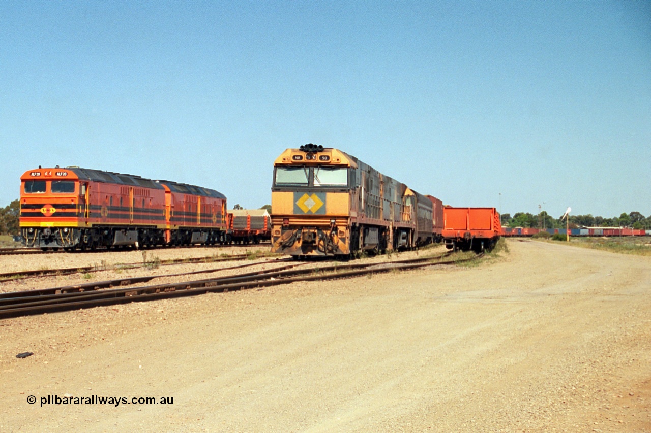 244-03
Port Augusta yard, a pair of ALF class units on the Darwin line construction shunt a rail transport waggon as an SP service wait for departure time with a pair of NR class units. ALF 20 and ALF 18 are both Morrison Knudsen rebuilds, model JT26C-2M serials 94-AN-020 and 94-AN-018.
Keywords: ALF-class;ALF18;ALF20;MKA;EMD;JT26C-2M;94-AN-018;94-AN-020;AL-class;NR-class;NR50;Goninan;GE;Cv40-9i;7250-08/97-252;