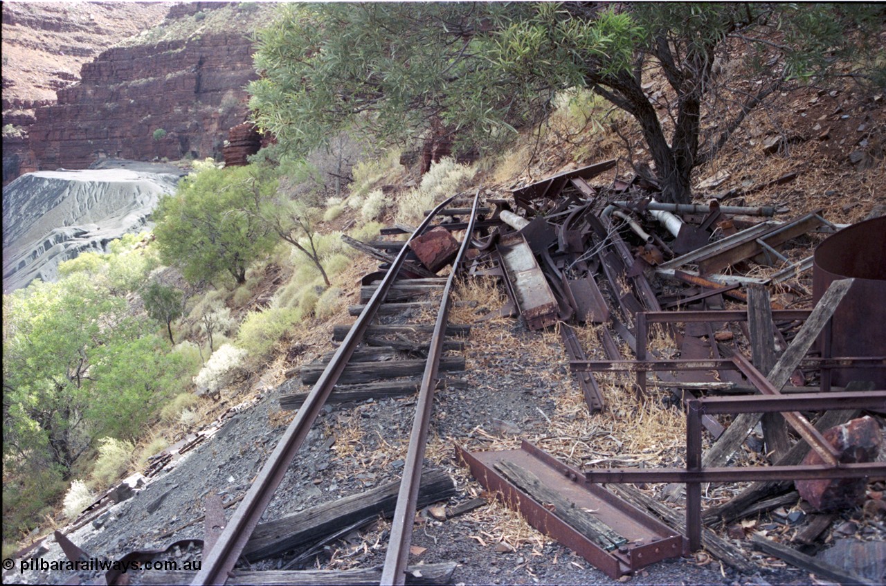 194-14
Wittenoom Gorge, Colonial Mine, asbestos mining remains, view looking sort of south west past scrap steel, tailings pile, track used to go around corner to other mine adits.
