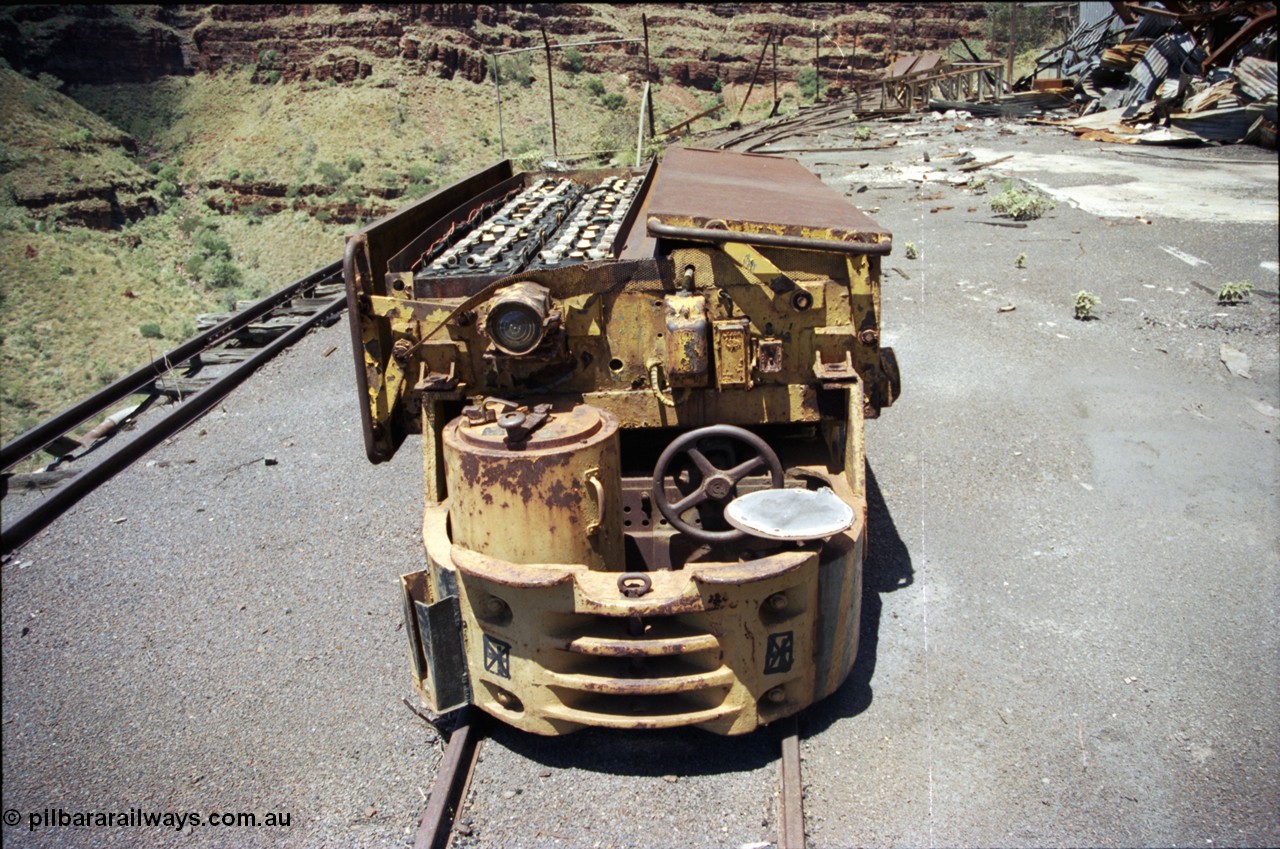 197-15
Wittenoom, Colonial Mine, asbestos mining remains, Mancha battery locomotive #4 looking south east, demolished workshops and office on the right with the battery charging shed remains in the distance. Drivers seat, brake wheel and controller.
Keywords: Mancha;