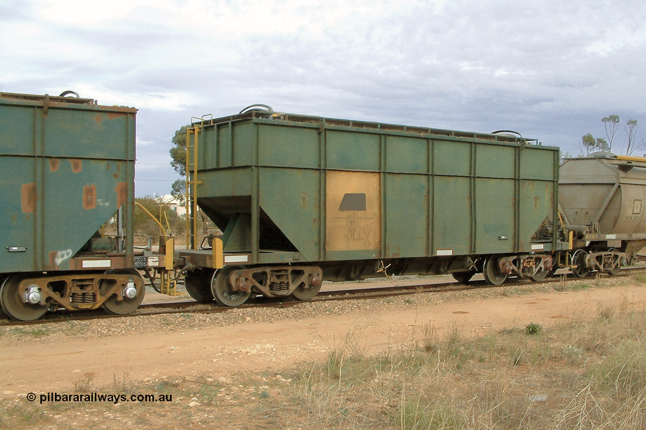 030407 082409
Wudinna, former Australian National narrow gauge ENHG type bogie grain waggon ENHG 6, originally built by Moore Road Ind, Victoria as NB type NB 1444 ballast hopper for the NAR, then to standard gauge in 1975 as BA type BA 1536, to EP July 1984, recoded to ENHT type ENHT 11 in 1985 and further rebuilt forming one half of ENHG type grain waggon in August 1986. The conversion involved splicing 2 AHTY-ENHT type waggons together at Port Lincoln Workshops. 7th April 2003.
Keywords: ENHG-type;ENHG6;Moore-Road-Ind-Victoria;NB-type;NB1444;BA-type;BA1536;ENHT-type;ENHT11;