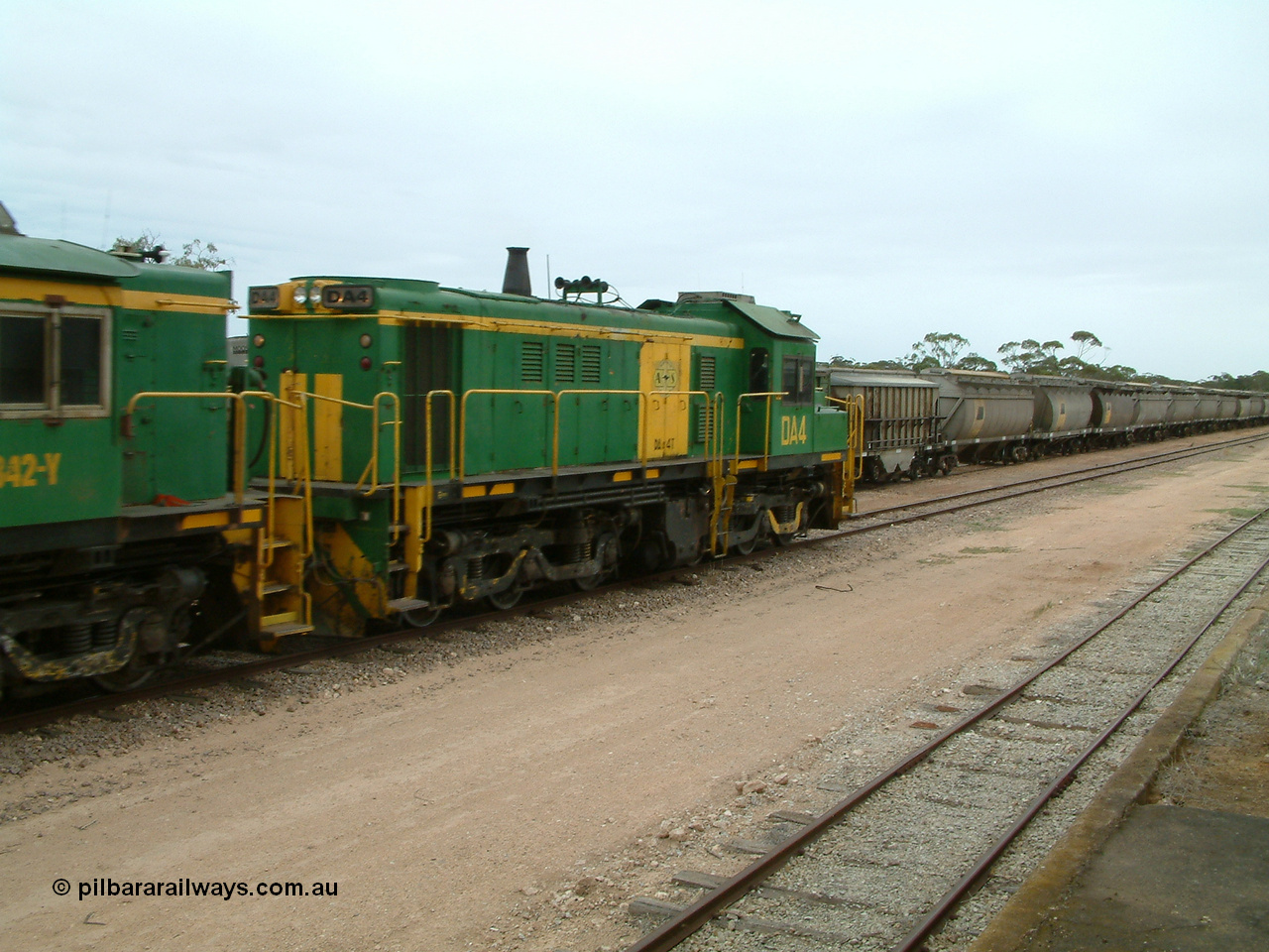 030407 114344
Poochera, empty grain train arrives behind former Australian National locomotive rebuilt from former AE Goodwin ALCo model DL531 830 class ex 839 serial 83730 by Port Augusta Workshops to DA class unit DA 4 to shunt off empty waggons and pick up the loaded ones. 7th April 2003.
Keywords: DA-class;DA4;83730;Port-Augusta-WS;ALCo;DL531G/1;830-class;839;rebuild;