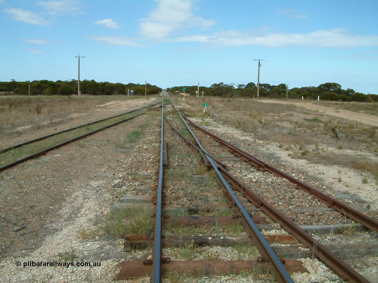 030409 125102
Rudall, view looking south from the south end, the goods and grain loop coming in from the left with the stub siding (former station loop) on the right.
