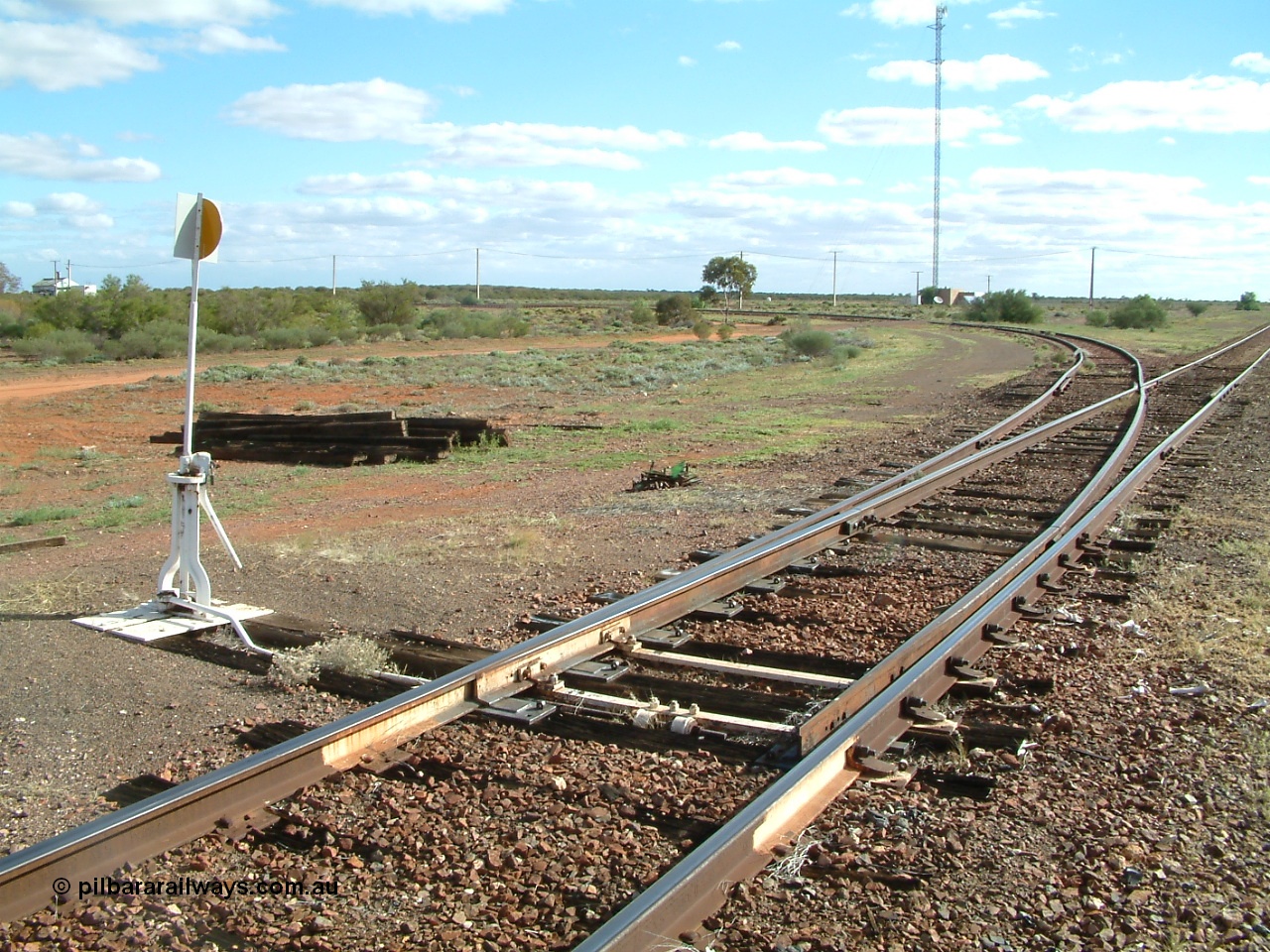 030415 154518
Tarcoola, at the 504.5 km, looking west along the eastern leg of the triangle, power station on the left, loop line running to the right. Tarcoola is the junction for the TAR and CAR railways situated 504 km from the 0 km datum at Coonamia. [url=https://goo.gl/maps/NmBNmrosE7e6d5gx8]GeoData location[/url]. 15th April 2003.
