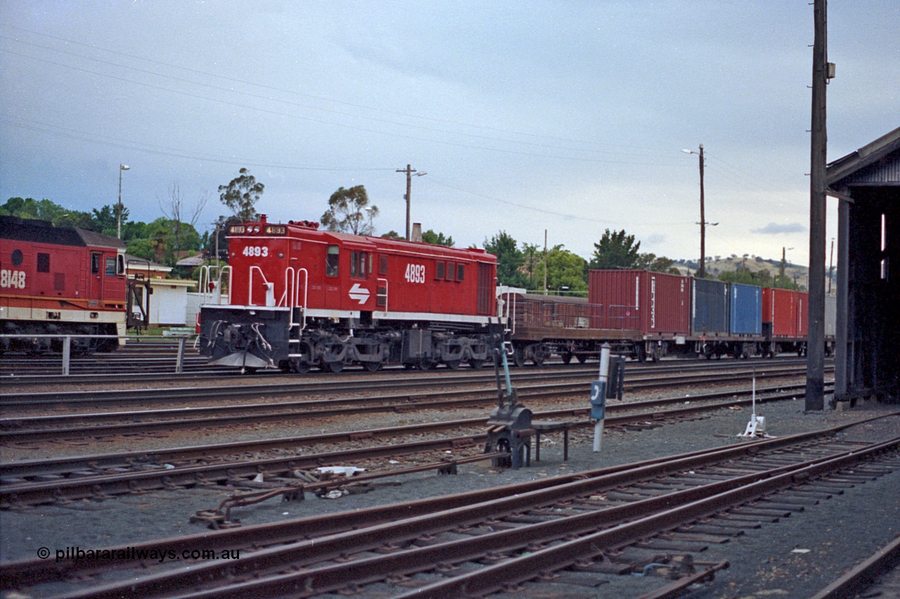 100-05
Albury yard view, NSWSRA standard gauge 48 class 4893 AE Goodwin ALCo model DL531 serial G3420-8, red terror livery, shunters float, 2 lever ground frame, point rodding, loco shed at right.
Keywords: 48-class;4893;AE-Goodwin;ALCo;DL531;G3420-8;