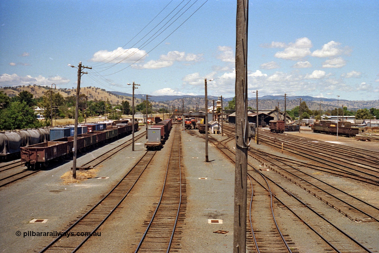100-15
Albury station yard overview, looking south from Wilson Street footbridge, NSWSRA standard gauge 81 class locos in background, goods sheds on the right. [url=https://goo.gl/maps/nngpTA37VQekQpCt7]Geodata[/url].
Keywords: 81-class;