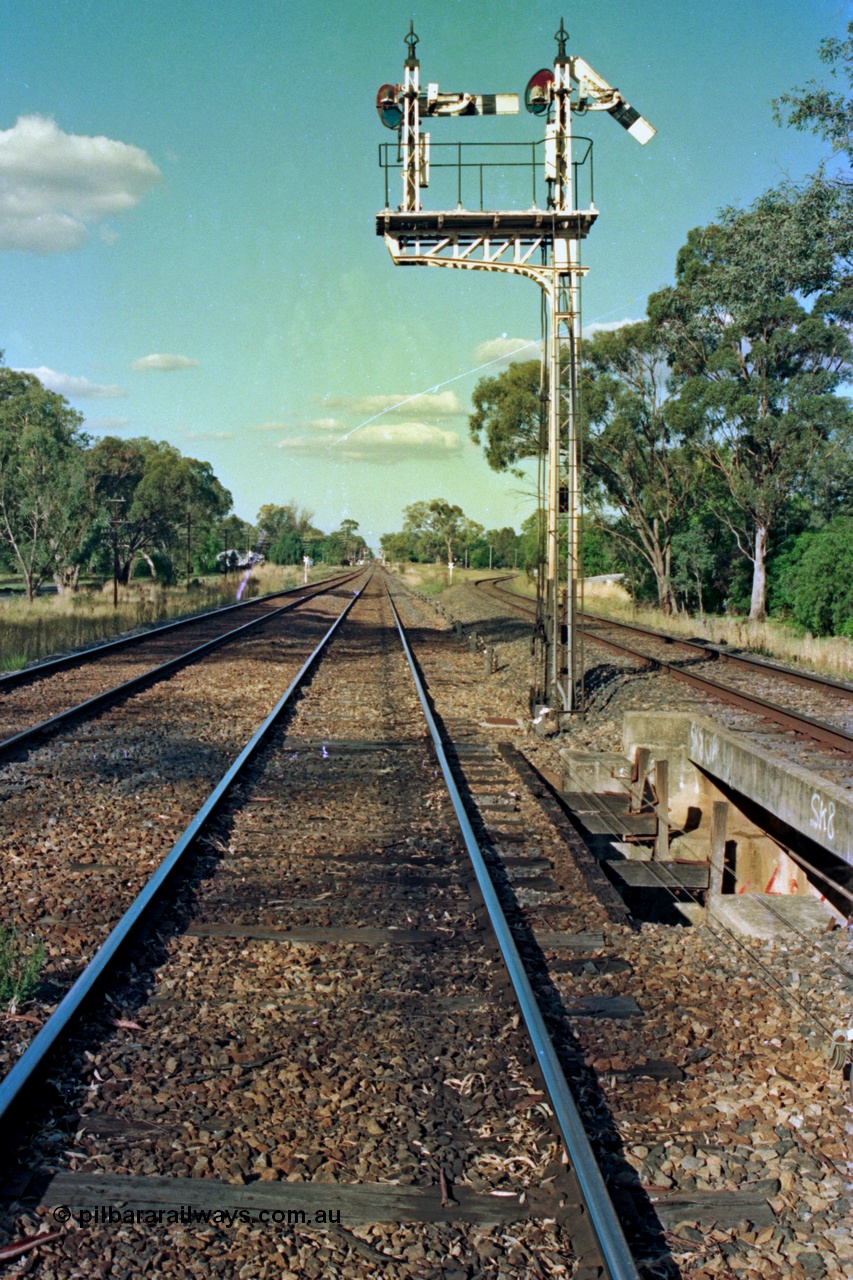 112-01
Violet Town broad gauge track view, looking north, up home semaphore signal post 3 pulled off for up passenger train, standard gauge line on right, March 1994.
