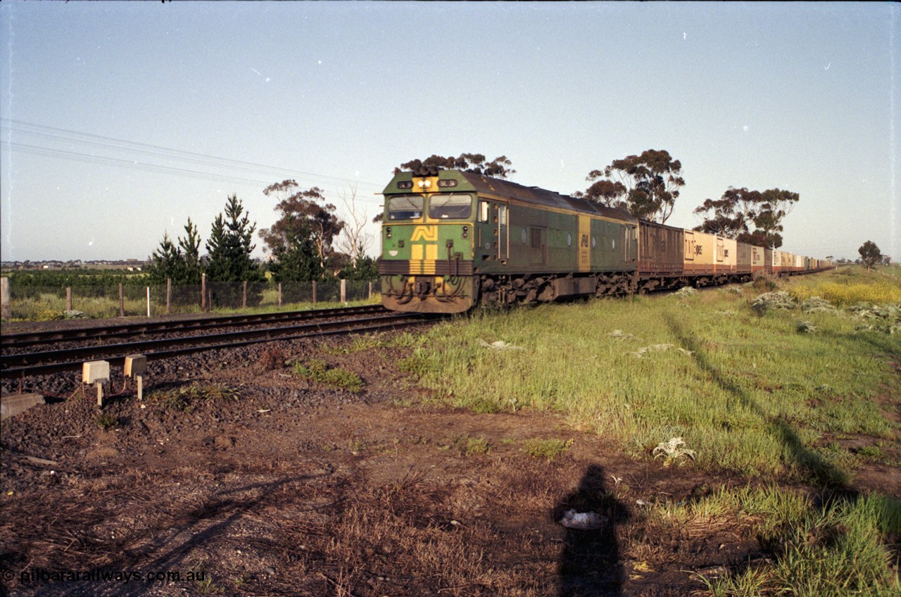 127-19
Deer Park West, broad gauge Australian National BL class BL 31 Clyde Engineering EMD model JT26C-2SS serial 83-1015 in AN livery leads an up goods train into Melbourne on the double track.
Keywords: BL-class;BL31;Clyde-Engineering-Rosewater-SA;EMD;JT26C-2SS;83-1015;