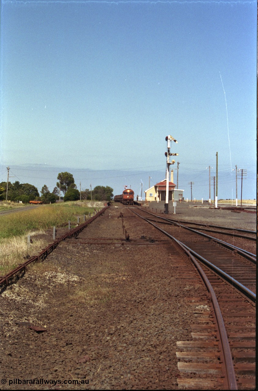 133-31
Gheringhap station yard overview, looking from Ballarat line points towards Geelong, semaphore signal post 4 pulled off for Cressy line, points, point rodding, signal wires and interlocking, V/Line broad gauge grain train 9123 swapping electric staff for train order for Maroona, safeworking.
Keywords: G-class;G533;Clyde-Engineering-Somerton-Victoria;EMD;JT26C-2SS;88-1263;