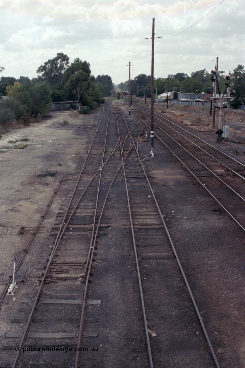 148-33
Wangaratta yard looking north (down direction) from footbridge at Nos. 5 and 4 Road extensions, point blades and K crossing for Siding J still in situ on No. 5 Road, double compound points on No. 4 Road to Siding 'C', then Main Line and Signal Post 23, standard gauge line in cutting at extreme right.
