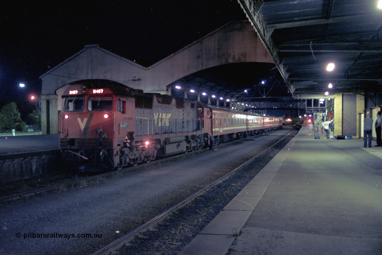 153-3-21
Geelong station building and platform, night shot, V/Line broad gauge N class N 467 'City of Stawell' Clyde Engineering EMD model JT22HC-2 serial 86-1196 with a 5 car N set prepares to cut off, driver looking at 2nd person on ground.
Keywords: N-class;N467;Clyde-Engineering-Somerton-Victoria;EMD;JT22HC-2;86-1196;