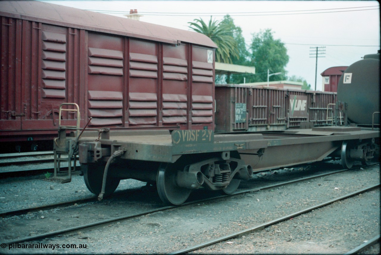 160-23
Shepparton, V/Line broad gauge VDSF type bogie safety waggon VDSF 2, started life as a Flexi-Van transport waggon FV 2 built by South Australian Railways' Islington Workshops in July 1961, then became FVF in 1962 on standard gauge, in the 1980s back to broad gauge and coded VQAY, VDSY and became VSDF in 1988, hand brake end showing ratchet style hand brake.
Keywords: VDSF-type;VDSF2;SAR-Islington-WS;FV-type;