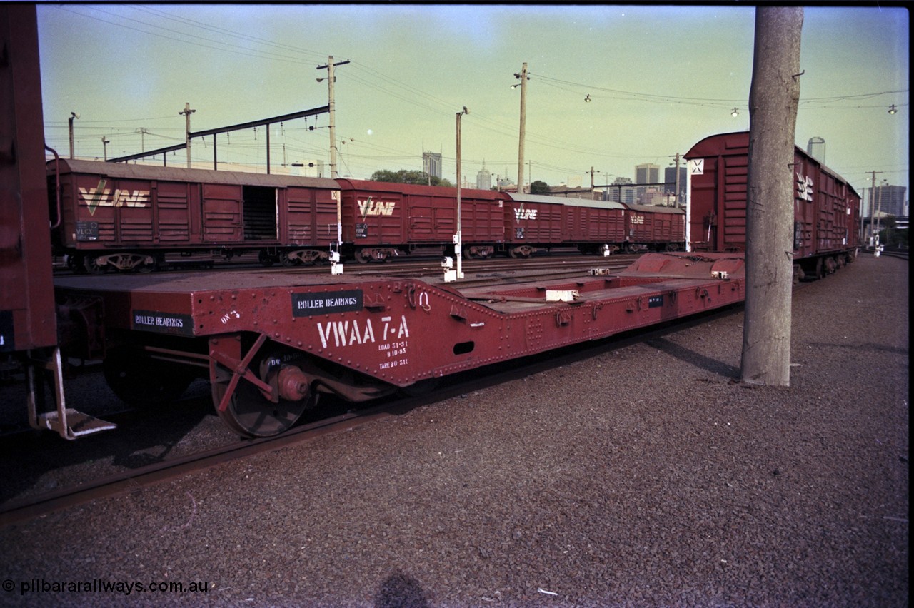 162-3-19
Melbourne Yard, V/Line broad gauge VWAA type bogie well waggon VWAA 7, built at Newport Workshops January 1913 as QB type bogie well - boiler transport waggon, fitted with container anchors which were fitted in 1975, behind it are VLCX, VBBF and VLDX type bogie louvre vans, VLCX 183, VBBF 124 and VLDX 1.
Keywords: VWAA-type;VWAA7;Victorian-Railways-Newport-WS;QB-type;