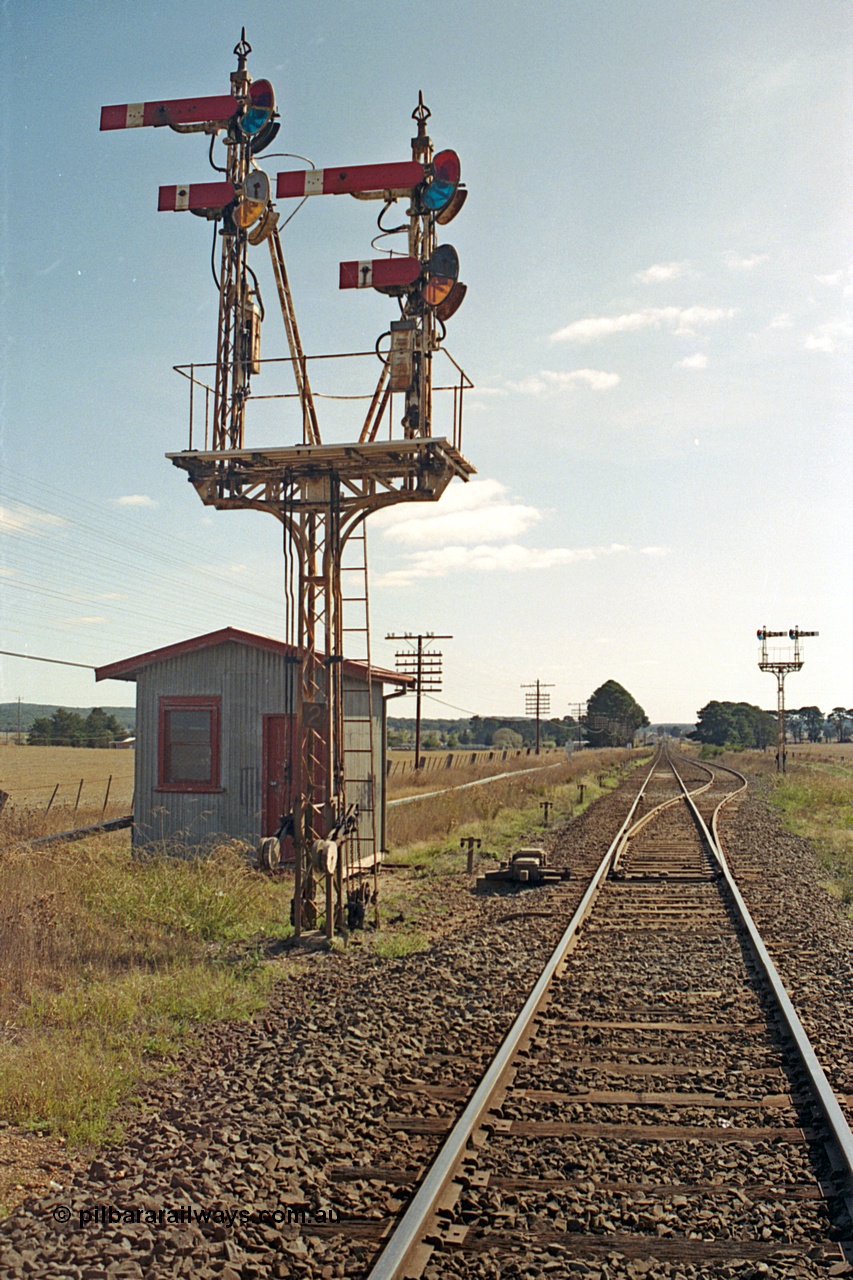 171-14
Trawalla station yard overview, looking towards Ararat, Down Home semaphore Signal Post 2 top arm on left hand Doll Home for Main Line to No. 1 Road to Post 5, bottom arm on left hand Doll Calling-on from Main Line to No.1 Road towards Post 5. Top arm on right hand Doll for Main Line to No. 2A Road to Post 4 and bottom Doll for Main Line to No. 2A Road towards Post 4. Motorised points, machine and electric interlocking room, semaphore Signal Post 3 facing up trains.
