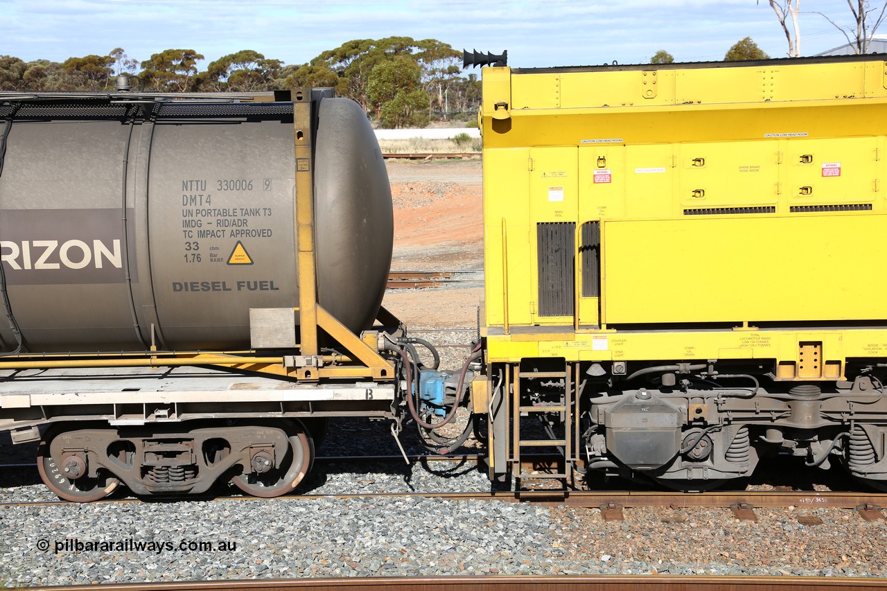 160525 4944
West Kalgoorlie, Aurizon intermodal train 2MP1. Shows back of second unit locomotive 6022 and the inline fuelling waggon QQFY 4271 and diesel fuel tanktainer NTTU 30006, visible are the MU or Multiple Unit red cable going into the socket with the cream cap on the waggon and the red cap on the loco, behind that is the crimp fitting is the in-line fuel hose between waggon and the loco along with train air pipe and coupling.
Keywords: QQFY-type;QQFY4271;Perry-Engineering-SA;RMX-type;AQMX-type;AQMY-type;RQMY-type;