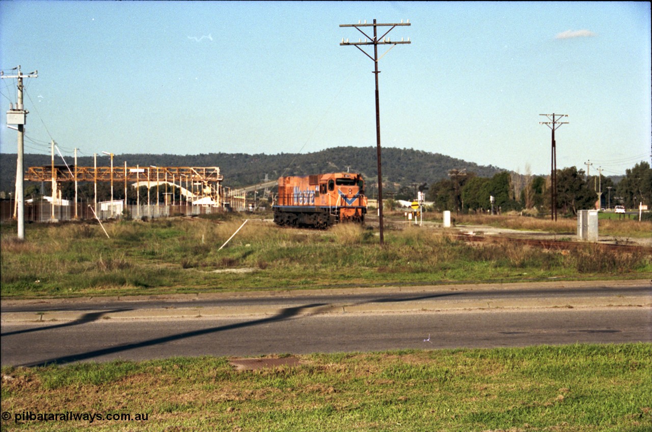 186-23
Bellevue, Westrail standard gauge light engine movement, train 168 stands in the flashbutt sidings prior to departure back to Forrestfield. NB class locomotive NB 1873 a Comeng built ALCo model CE618 serial WA-79 / C6099-3. This unit was originally a WAGR N class on narrow gauge, then reclassed to NA when fitted with air brakes in 1983, and then fitted with ex Mt Newman Mining ALCo M636 bogies in 1994 and classed NB.
Keywords: NB-class;NB1873;Comeng-WA;ALCo;CE618;WA-79/C6099-3;N-class;NA-class;rebuild;