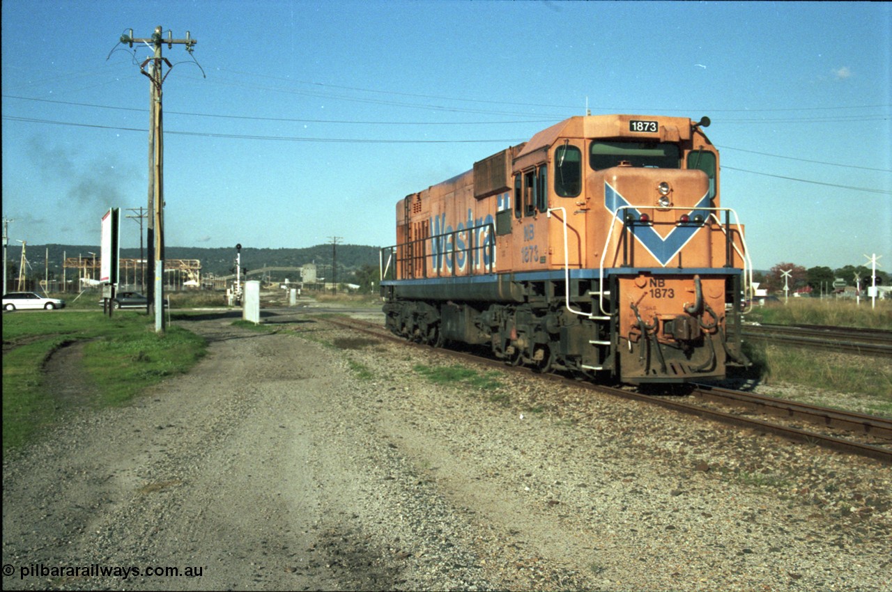 186-26
Bellevue, Westrail standard gauge light engine movement, train 168 departs the flashbutt sidings crossing Lloyd Street bound for Forrestfield. NB class locomotive NB 1873 a Comeng built ALCo model CE618 serial WA-79 / C6099-3. This unit was originally a WAGR N class on narrow gauge, then reclassed to NA when fitted with air brakes in 1983, and then fitted with ex Mt Newman Mining ALCo M636 bogies in 1994 and classed NB.
Keywords: NB-class;NB1873;Comeng-WA;ALCo;CE618;WA-79/C6099-3;N-class;NA-class;rebuild;