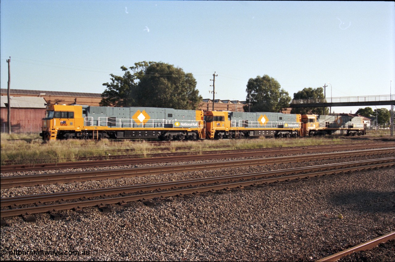 186-27
Midland, standard gauge yard, brand new Perth built National Rail NR class units NR 102 Goninan built GE model Cv40-9i serial 7250-07/97-302 and NR 101 serial 7250-07/97-303 shunt into the yard with the first Perth built sister NR 61 serial 7250-11/96-263.
Keywords: NR-class;NR102;Goninan;GE;Cv40-9i;7250-07/97-302;