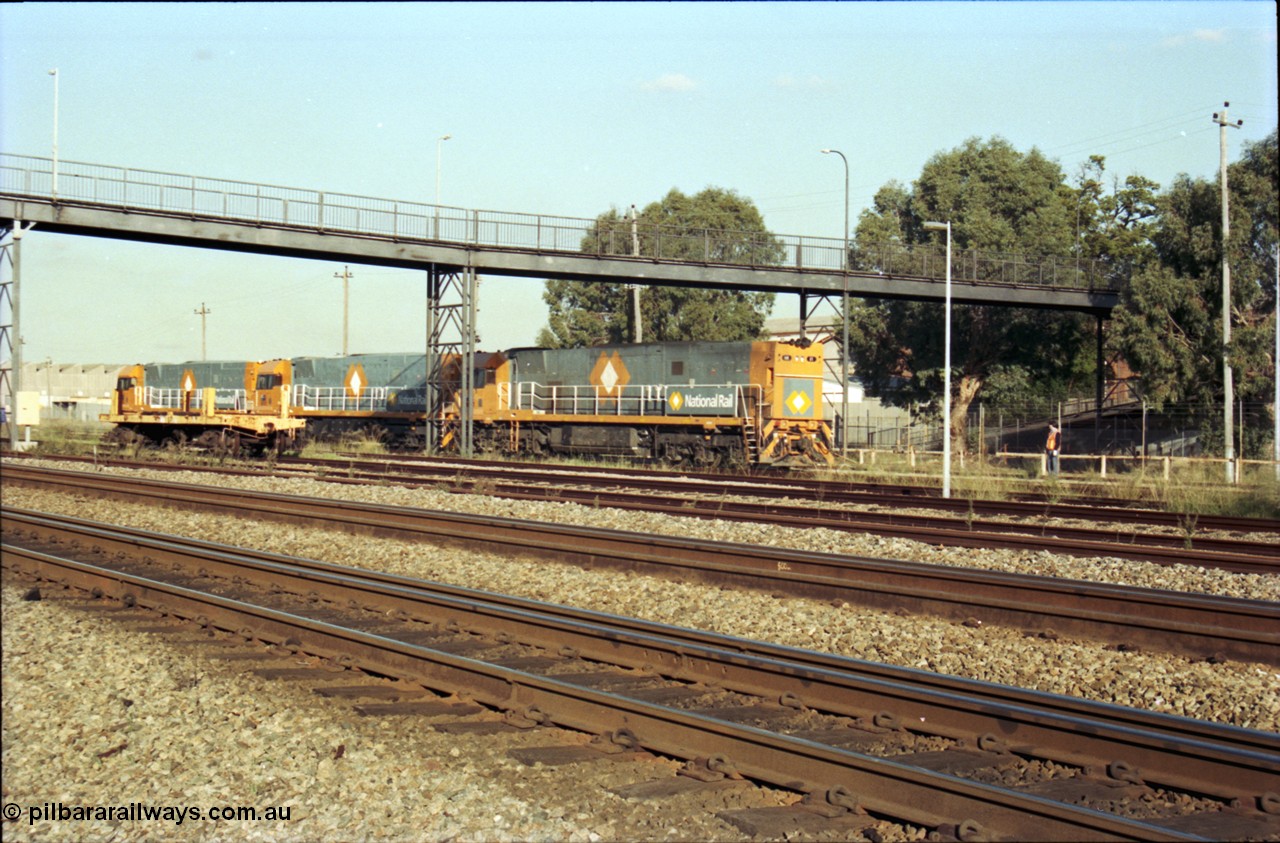 186-32
Midland, standard gauge yard, brand new Perth built National Rail NR class units NR 102 Goninan GE model Cv40-9i serial 7250-07/97-302 and NR 101 serial 7250-07/97-303 shunt out of the yard with the first built sister NR 61 serial 7250-11/96-263.
Keywords: NR-class;NR61;Goninan;GE;Cv40-9i;7250-11/96-263;