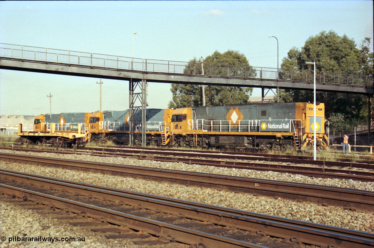 186-33
Midland, standard gauge yard, brand new Perth built National Rail NR class units NR 102 Goninan GE model Cv40-9i serial 7250-07/97-302 and NR 101 serial 7250-07/97-303 shunt out of the yard with the first built sister NR 61 serial 7250-11/96-263.
Keywords: NR-class;NR61;Goninan;GE;Cv40-9i;7250-11/96-263;