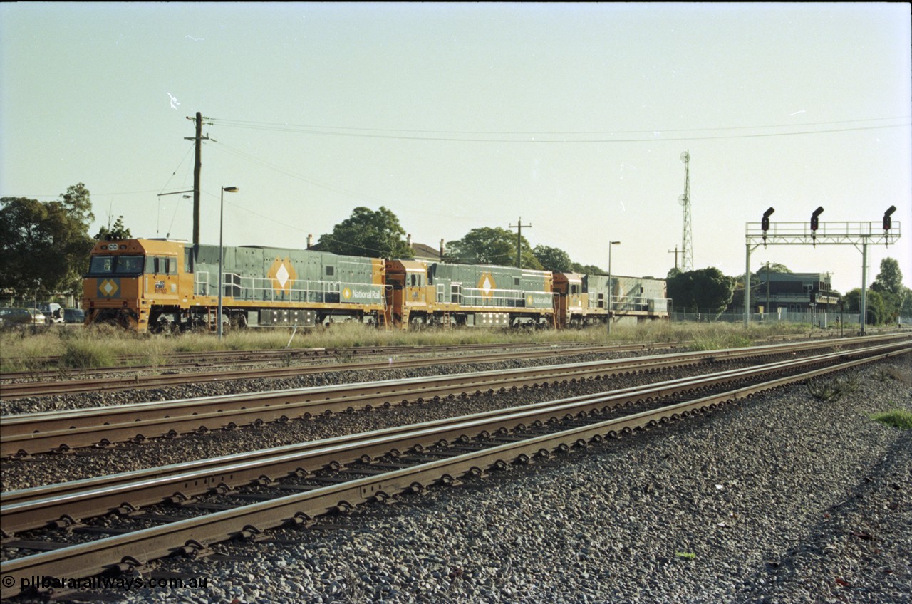 186-36
Midland, standard gauge yard, brand new Perth built National Rail NR class units NR 102 Goninan GE model Cv40-9i serial 7250-07/97-302 and NR 101 serial 7250-07/97-303 shunt out of the yard with the first built sister NR 61 serial 7250-11/96-263, the building in the background is MidSig, the train control building, the yard and signal gantry are now gone.
Keywords: NR-class;NR102;Goninan;GE;Cv40-9i;7250-07/97-302;