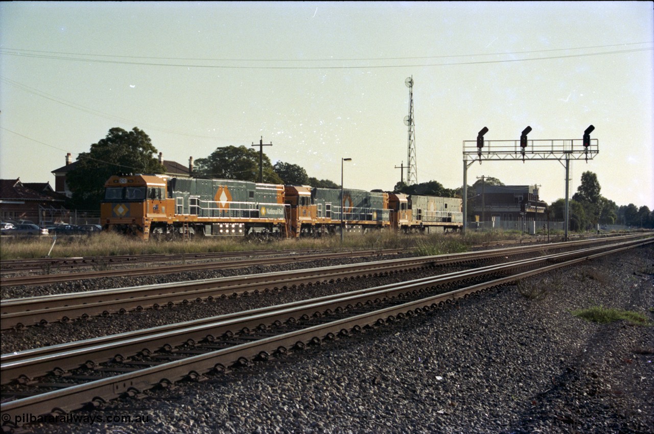 186-37
Midland, standard gauge yard, brand new Perth built National Rail NR class units NR 102 Goninan GE model Cv40-9i serial 7250-07/97-302 and NR 101 serial 7250-07/97-303 shunt out of the yard with the first built sister NR 61 serial 7250-11/96-263, the building in the background is MidSig, the train control building, the yard and signal gantry are now gone.
Keywords: NR-class;NR102;Goninan;GE;Cv40-9i;7250-07/97-302;