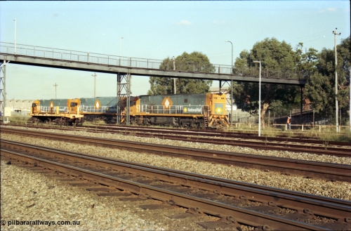 186-32
Midland, standard gauge yard, brand new Perth built National Rail NR class units NR 102 Goninan GE model Cv40-9i serial 7250-07/97-302 and NR 101 serial 7250-07/97-303 shunt out of the yard with the first built sister NR 61 serial 7250-11/96-263.
Keywords: NR-class;NR61;Goninan;GE;Cv40-9i;7250-11/96-263;