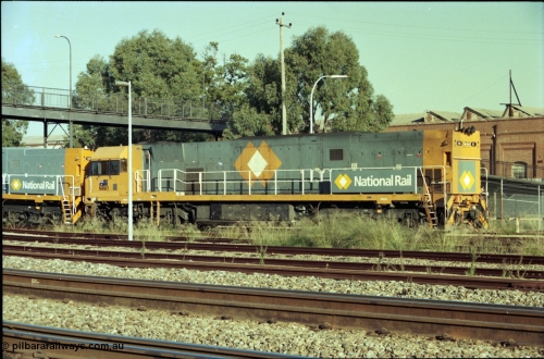 186-34
Midland, standard gauge yard, under the Midland Workshops footbridge, the first completed and built in Bassendean, National Rail NR class NR 61 Goninan GE model Cv40-9i serial 7250-11/96-263 trails new sisters NR 101 and NR 102 as they perform their shunt movement back out towards the mainline.
Keywords: NR-class;NR61;Goninan;GE;Cv40-9i;7250-11/96-263;