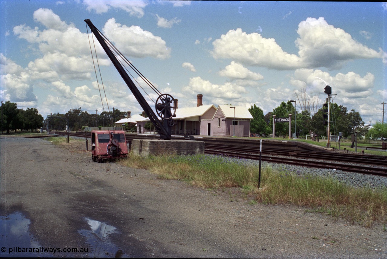 189-07
The Rock, located at the 550.29 km on NSW Main South line, station platform and building with the goods loading crane and track inspection car, the Back Road is visible mid frame at left.
