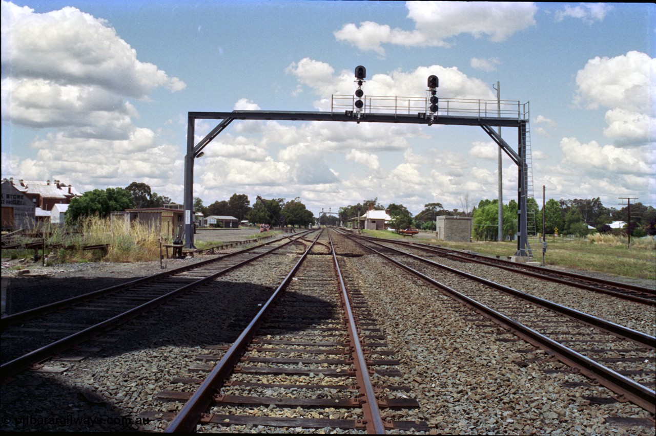 189-08
The Rock, located at the 550.29 km on NSW Main South line, view looking north with the along the Up Loop with the Up Siding at left, Mainline on the right and the Down Loop at far right, ground frame C is just in front of the signal bridge, loading crane and inspection car can be seen opposite the station.
