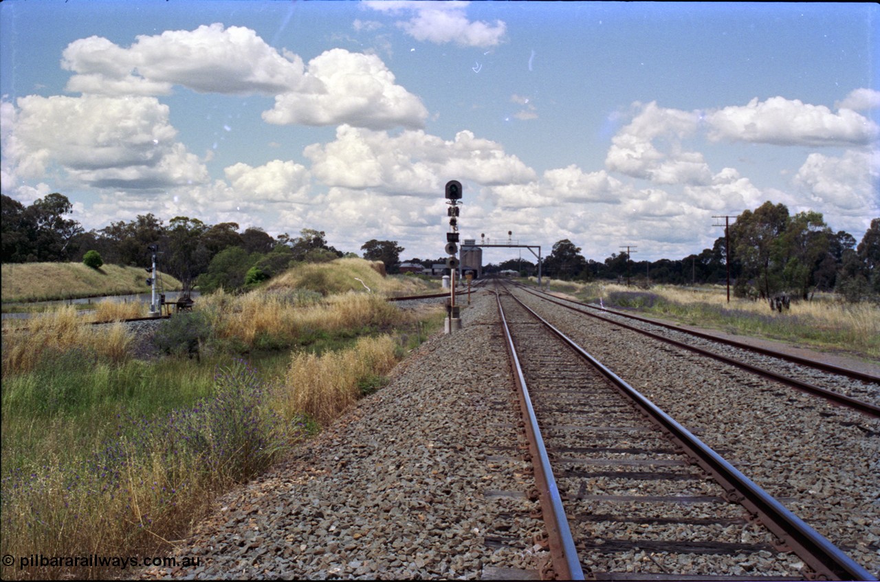 189-10
The Rock, located at the 550.29 km on NSW Main South line, view looking north with the along the Mainline with the Down Loop at right and the branch line to Oaklands coming in on the left with the ground frame E and signal, the No. 54 points from the Mainline to Up Loop are visible in front of the signal bridge.
