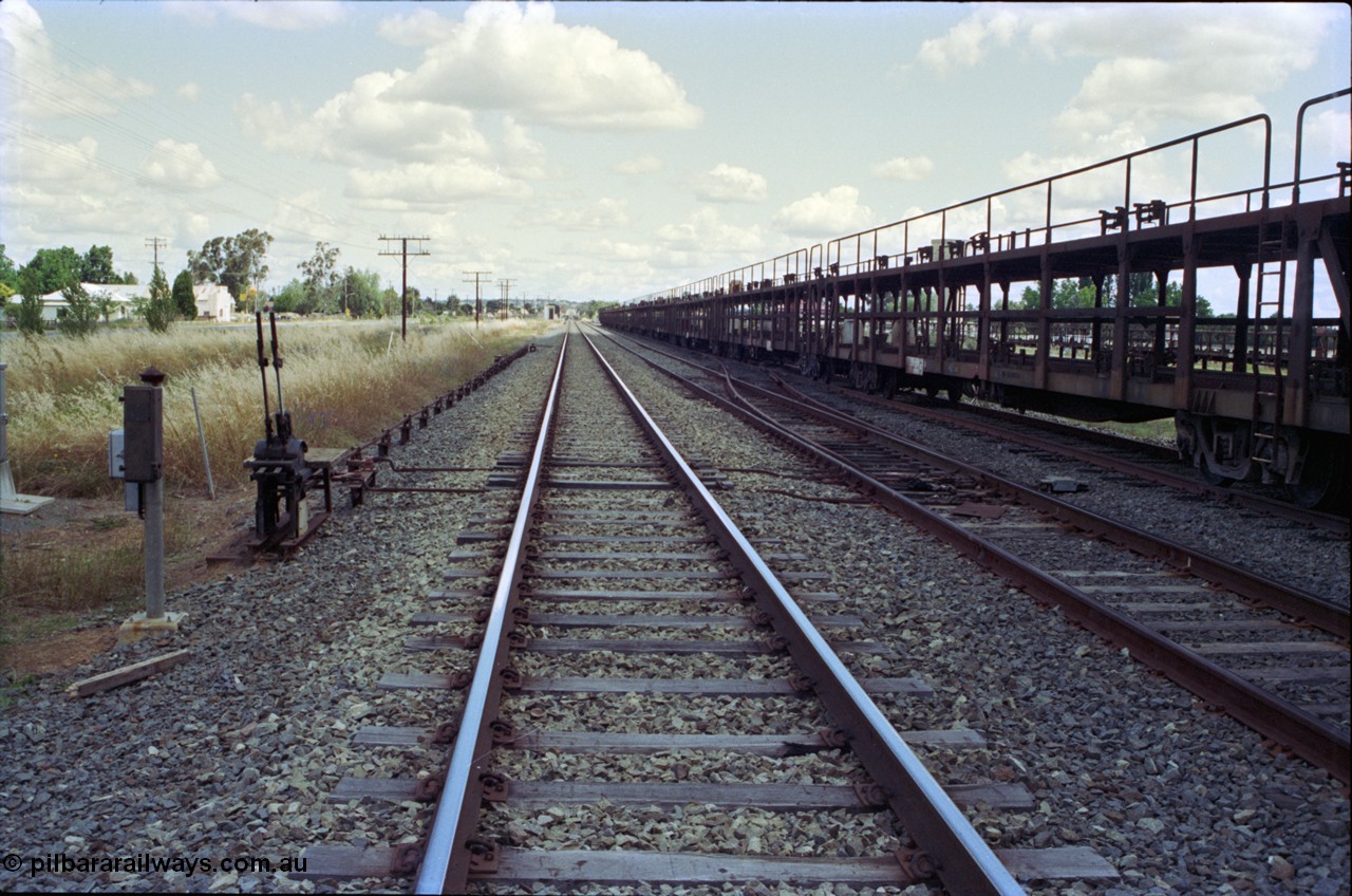 189-17
Yerong Creek, located at the 565.08 km on the NSW Main South line, view looking south along the mainline, then the Loop and Goods Siding with stored car carrying waggons, ground frame C and the points from the loop to siding.
