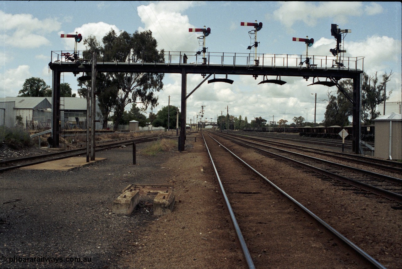 190-05
Cootamundra, NSW Main South, looking north, signal gantry with standpipe foundation in front, platform behind, dock road on the left.
