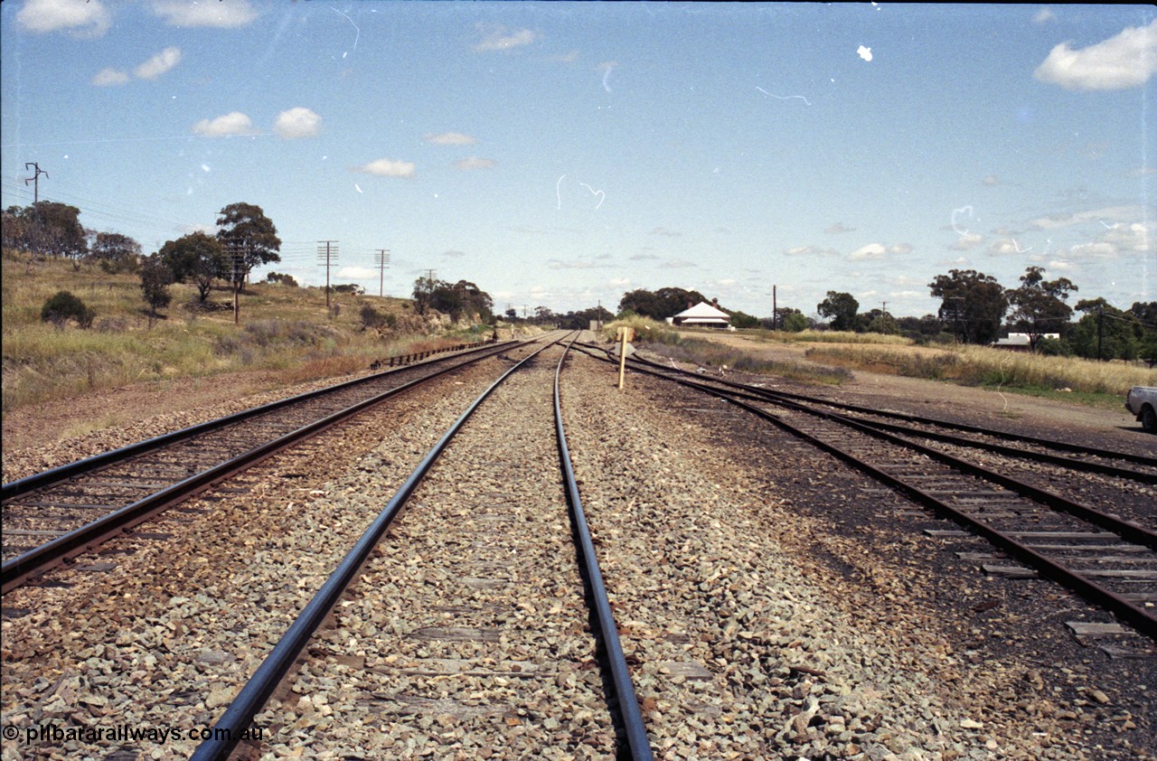 190-26
Bethungra, located at the 456.04 km on the NSW Main South line, looking south along the Up Main through the former station location with ground frame B for the trailing crossover visible on the left and the goods yard on the right.
