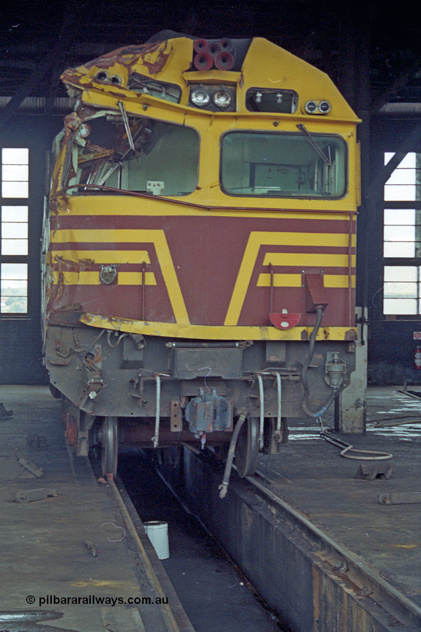 192-02
Junee, NSWSRA standard gauge locomotive depot, front view of accident damaged NSWGR 80 class unit 8020 inside the roundhouse. An ALCo CE615A model with Mitsubishi electrics built by Comeng NSW in 1979 serial C6106-20.
Keywords: 80-class;8020;Comeng-NSW;ALCo;CE615A;C6106-20;