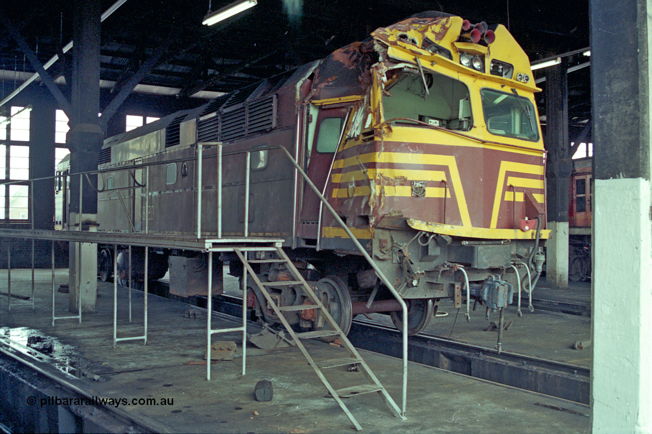 192-03
Junee, NSWSRA standard gauge locomotive depot, accident damaged NSWGR 80 class unit 8020 inside the roundhouse. An ALCo CE615A model with Mitsubishi electrics built by Comeng NSW in 1979 serial C6106-20.
Keywords: 80-class;8020;Comeng-NSW;ALCo;CE615A;C6106-20;