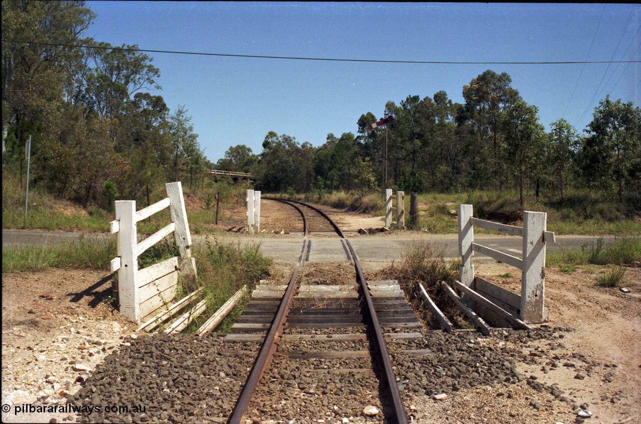 193-14
Moodlu, old grade crossing, looking west in Down direction across what is now Devantier Rd grade crossing, signal is for the Moodlu Quarry junction which is just around the curve. [url=https://goo.gl/maps/DarAzunp67r]GeoData[/url].
