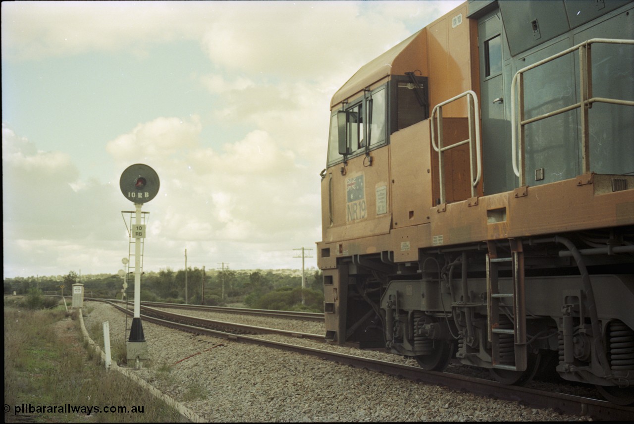 199-07
Meckering, National Rail NR class unit NR 19 Goninan built GE Cv40-9i model heads up train 7PM5 as it waits for a cross with the Prospector in the loop 1400 hrs 21st June 1997.
Keywords: NR-class;NR19;Goninan;GE;CV40-9i;7250-03/97-221;