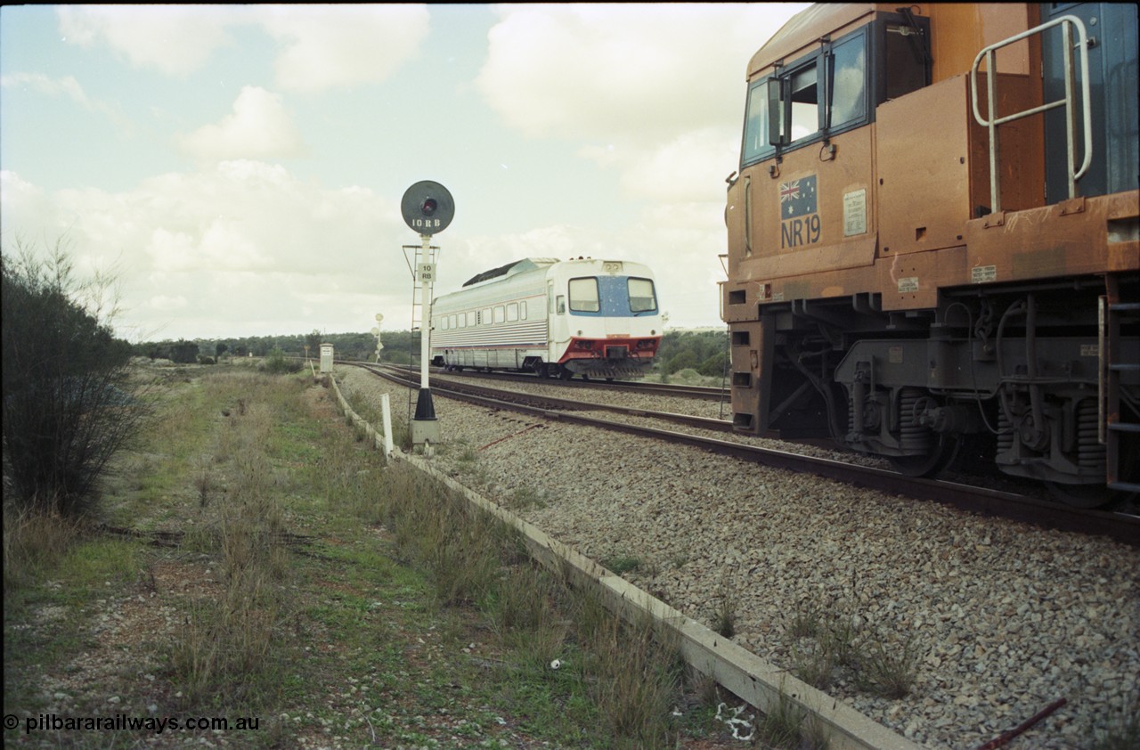 199-15
Meckering, Perth bound single Prospector car races along on the mainline as it crosses NR 19 on 7PM5 freighter.
Keywords: NR-class;NR19;Goninan;GE;CV40-9i;7250-03/97-221;