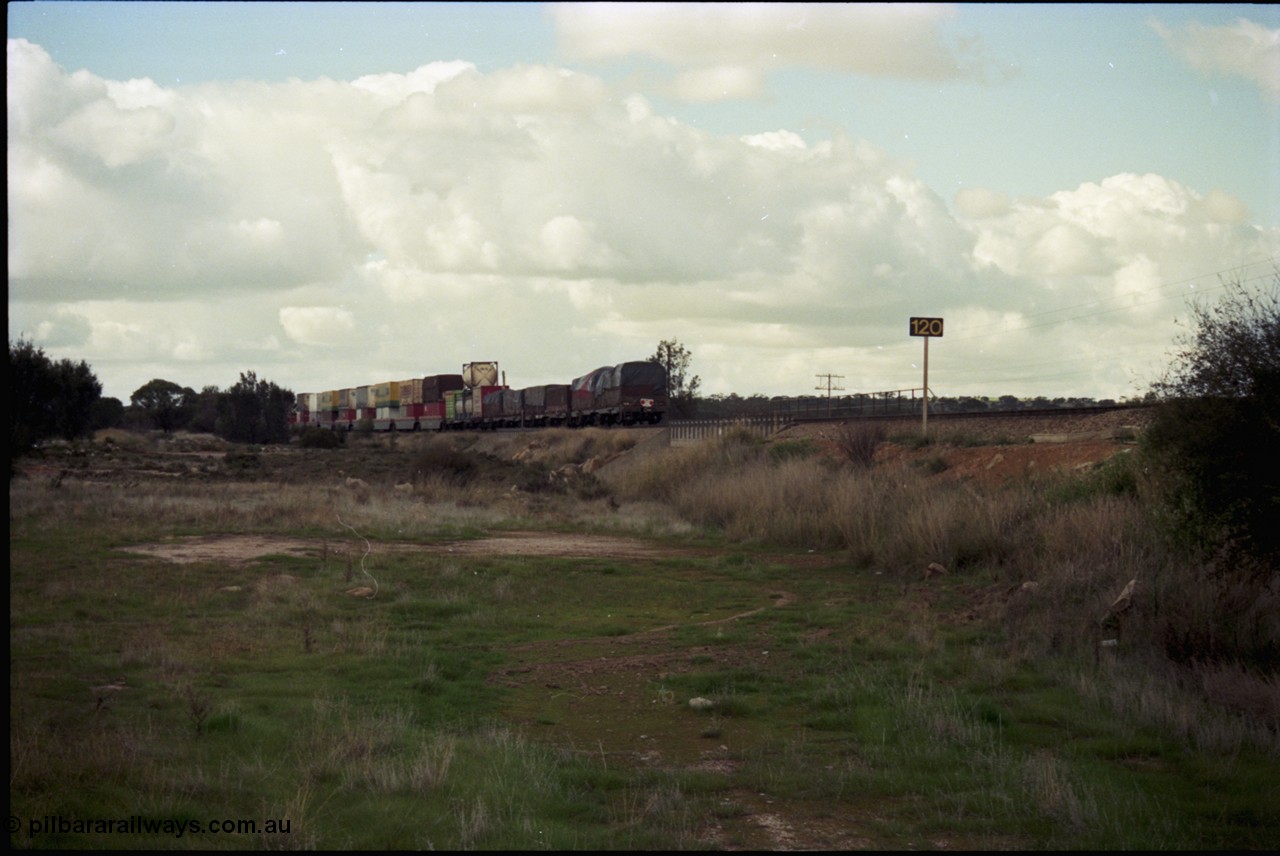 199-23
Meckering, train 7PM5 double stacked east bound with tarped loads on the rear, 21st June 1997.
