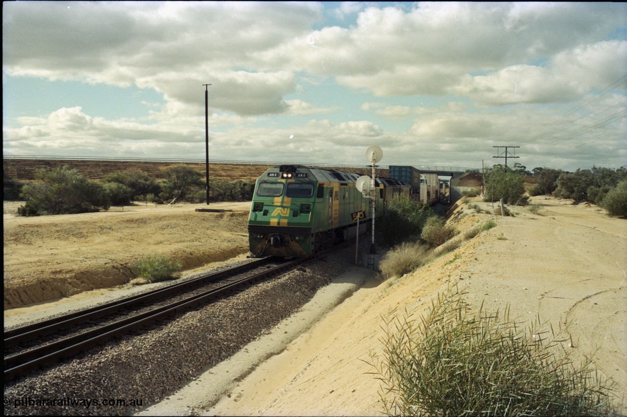 199-25
Moorine Rock, Australian National AN class unit AN 6 a Clyde Engineering EMD model JT46C serial 93-1302 built in Somerton Victoria and rebuild ALF class ALF 24 arrive on the mainline with a Perth bound freight 22nd June 1997.
Keywords: AN-class;AN6;Clyde-Engineering-Somerton-Victoria;EMD;JT46C;93-1302;