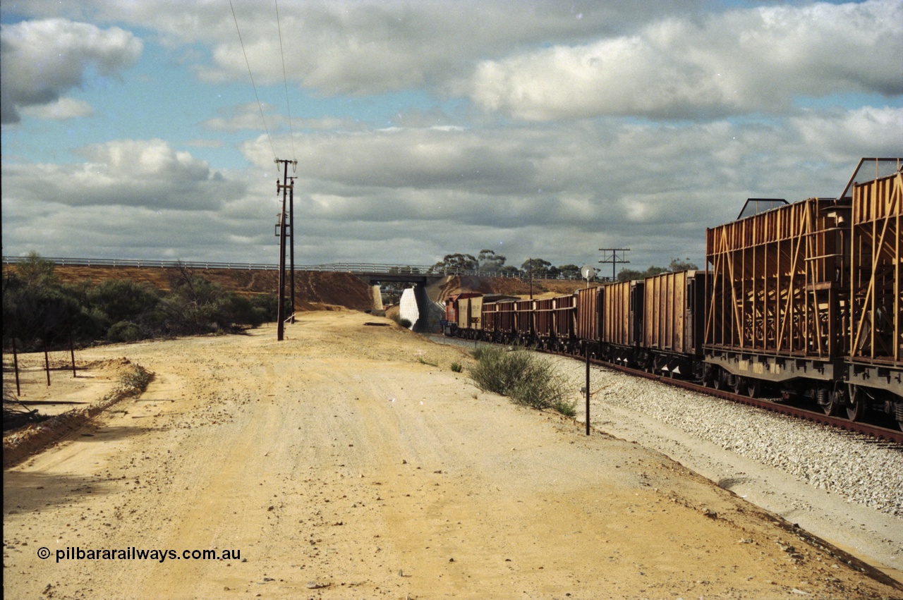 200-05
Moorine Rock, Westrail L class 271 Clyde Engineering EMD model GT26C serial 69-620 runs through the loop with the ballast cleaning train, known as the Circus Train while a Perth bound freighter sits in the mainline, 22nd June 1997.
