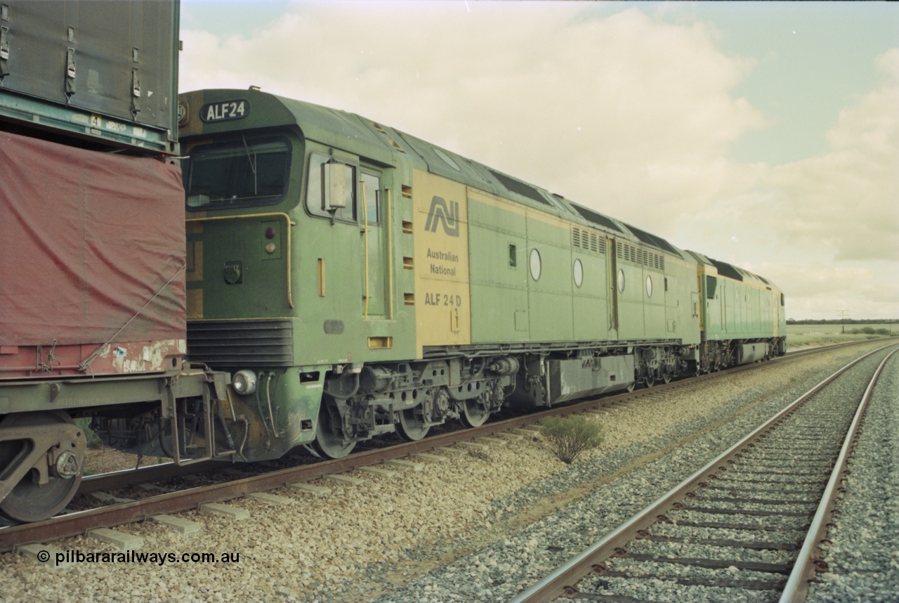 200-14
Moorine Rock, Australian National ALF class ALF 24 a Morrison Knudson rebuild of the AL class, new model being JT26C-2M and serial 94-AN-024, on the mainline with a Perth bound freight with AN class AN 6 Clyde Engineering EMD model JT46C serial 93-1302 on the lead 22nd June 1997.
Keywords: ALF-class;ALF24;Morrison-Knudson;EMD;JT26C-2M;94-AN-024;rebuild;AL-class;AL22;JT26C;76-838;