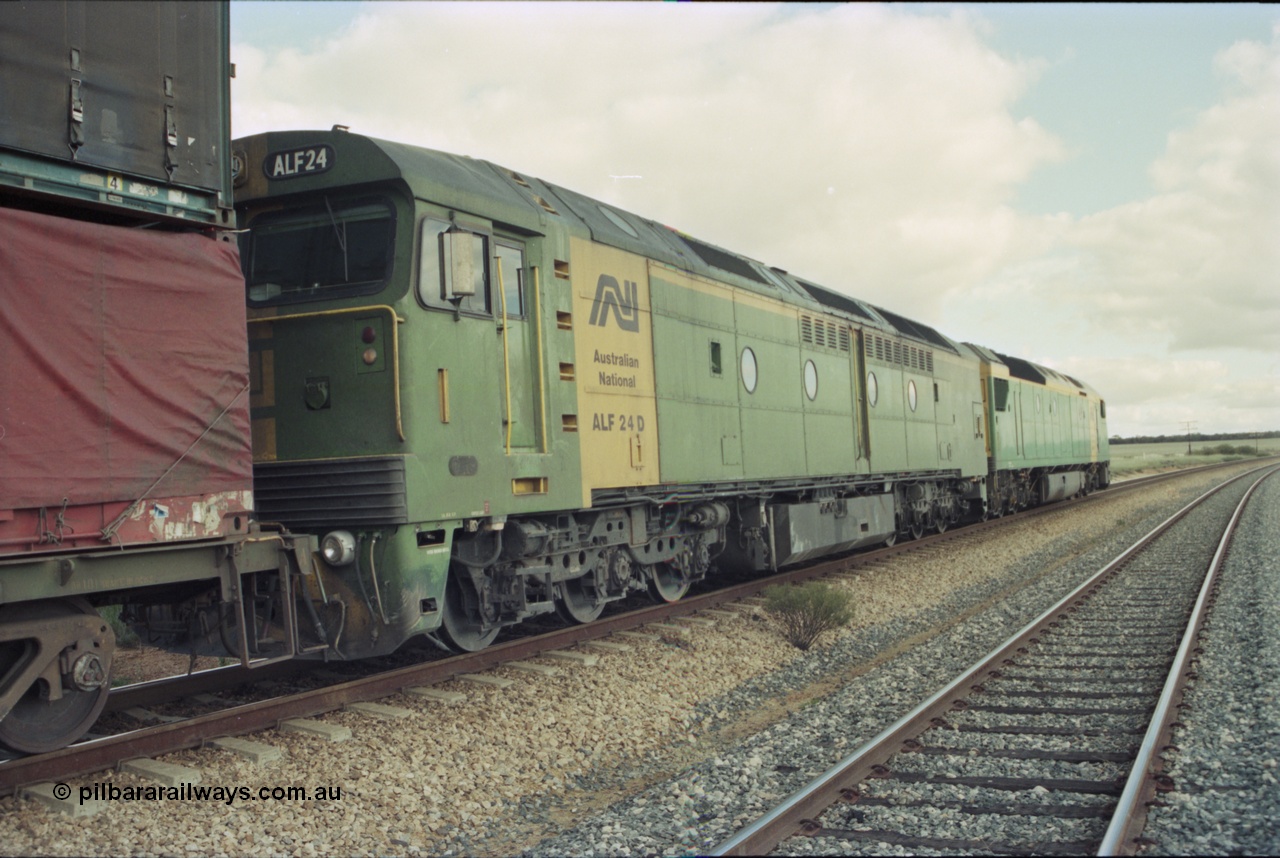 200-15
Moorine Rock, Australian National ALF class rebuild unit ALF 24, Morrison Knudson rebuilt the AL class into the ALF with the new model being JT26C-2M and serial 94-AN-024, on the mainline with a Perth bound freight with AN class AN 6 a Clyde Engineering built EMD model JT46C serial 93-1302 on the lead, 22nd June 1997.
Keywords: ALF-class;ALF24;Morrison-Knudson;EMD;JT26C-2M;94-AN-024;rebuild;AL-class;AL22;JT26C;76-838;