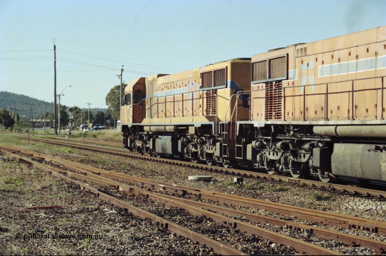 200-23
Midland, Westrail's Clyde Engineering built EMD model G26C as the DA class, DA 1573 serial 72-760 and DA 1574 serial 72-761 lead an empty grain train to Avon near the Lloyd Street grade crossing, 0925 hrs 24th June 1997.
Keywords: DA-class;DA1573;Clyde-Engineering-Granville-NSW;EMD;G26C;72-760;