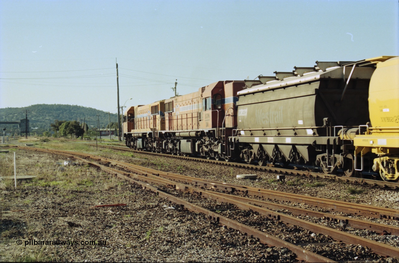 200-24
Midland, Westrail's Clyde Engineering built EMD model G26C as the DA class, DA 1573 serial 72-760 and DA 1574 serial 72-761 lead an empty grain train to Avon near the Lloyd Street grade crossing, lead waggon is an XNW type with the second being an XWBB type 2129, 0925 hrs 24th June 1997.
Keywords: DA-class;DA1573;Clyde-Engineering-Granville-NSW;EMD;G26C;72-760;