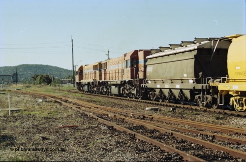 200-24
Midland, Westrail's Clyde Engineering built EMD model G26C as the DA class, DA 1573 serial 72-760 and DA 1574 serial 72-761 lead an empty grain train to Avon near the Lloyd Street grade crossing, lead waggon is an XNW type with the second being an XWBB type 2129, 0925 hrs June 24, 1997.
Keywords: DA-class;DA1573;Clyde-Engineering-Granville-NSW;EMD;G26C;72-760;