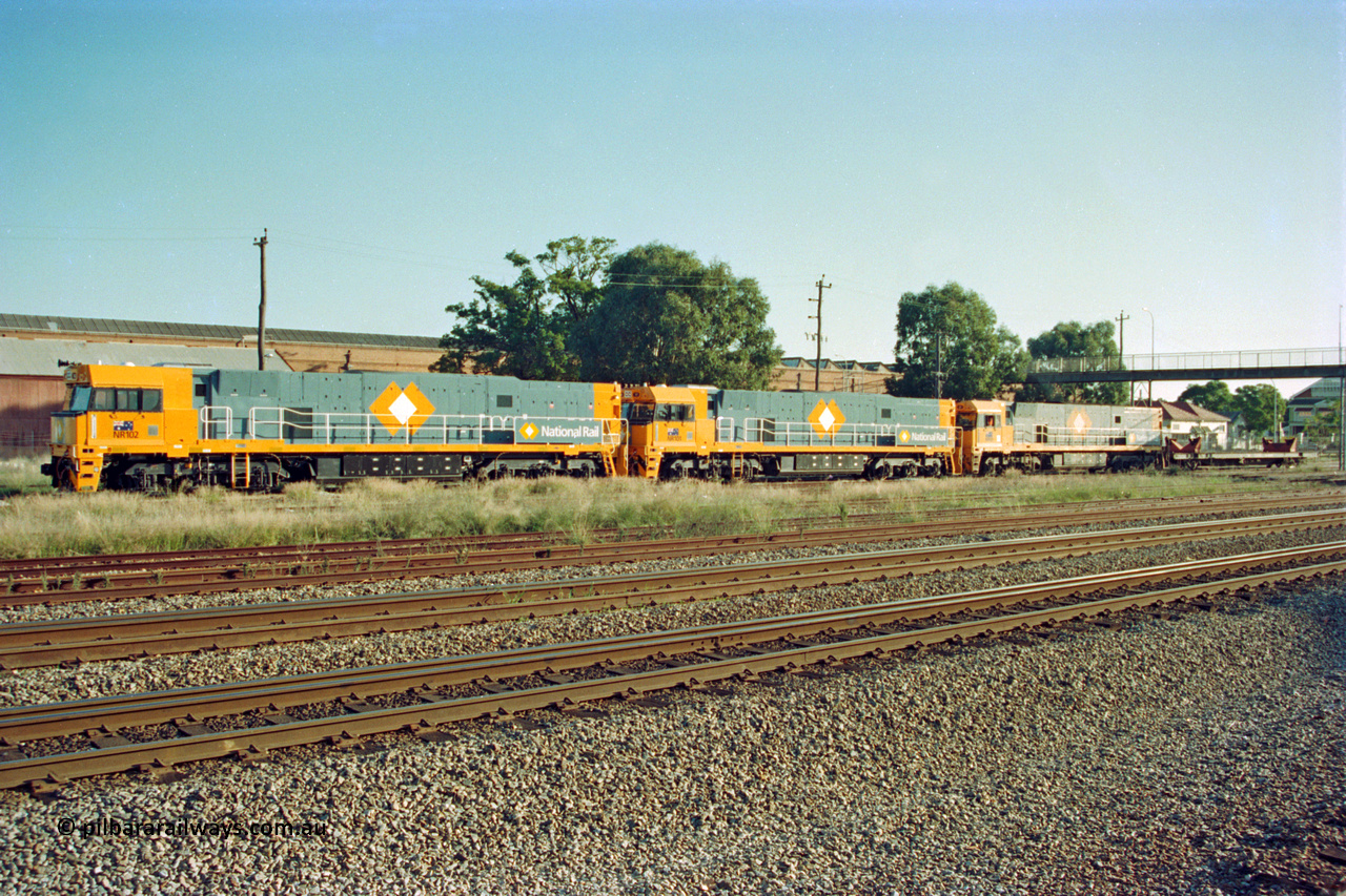 201-00
Midland, two brand Goninan WA built GE Cv40-9i model NR class units NR 102 serial 7250-07/97-302 and NR 101 serial 7250-07/97-303 lead the original Perth built NR 61 serial 7250-11/96-263 as the shunt around the yard.
Keywords: NR-class;NR102;Goninan;GE;CV40-9i;7250-07/97-302;