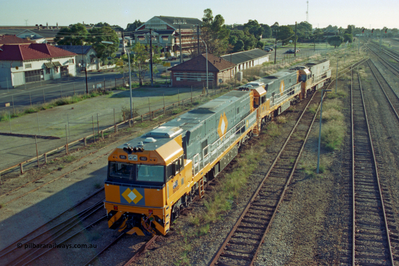 201-16
Midland, two brand Goninan WA built GE Cv40-9i model NR class units NR 102 serial 7250-07/97-302 and NR 101 serial 7250-07/97-303 lead the original Perth built NR 61 serial 7250-11/96-263 as the shunt around the yard.
Keywords: NR-class;NR102;Goninan;GE;CV40-9i;7250-07/97-302;